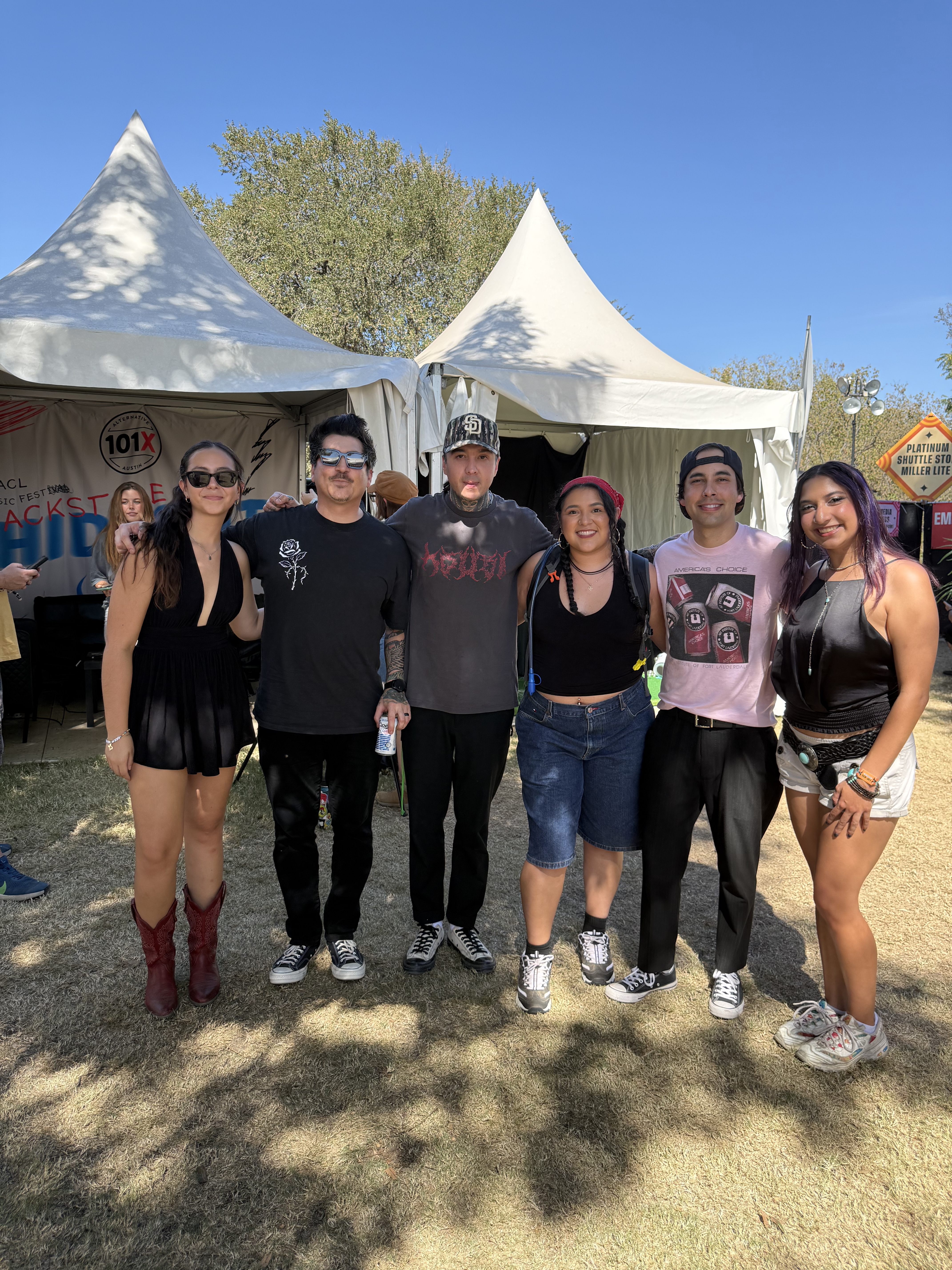 A photo of KANM's own Faye Merrit with members of the band Pierce the Veil