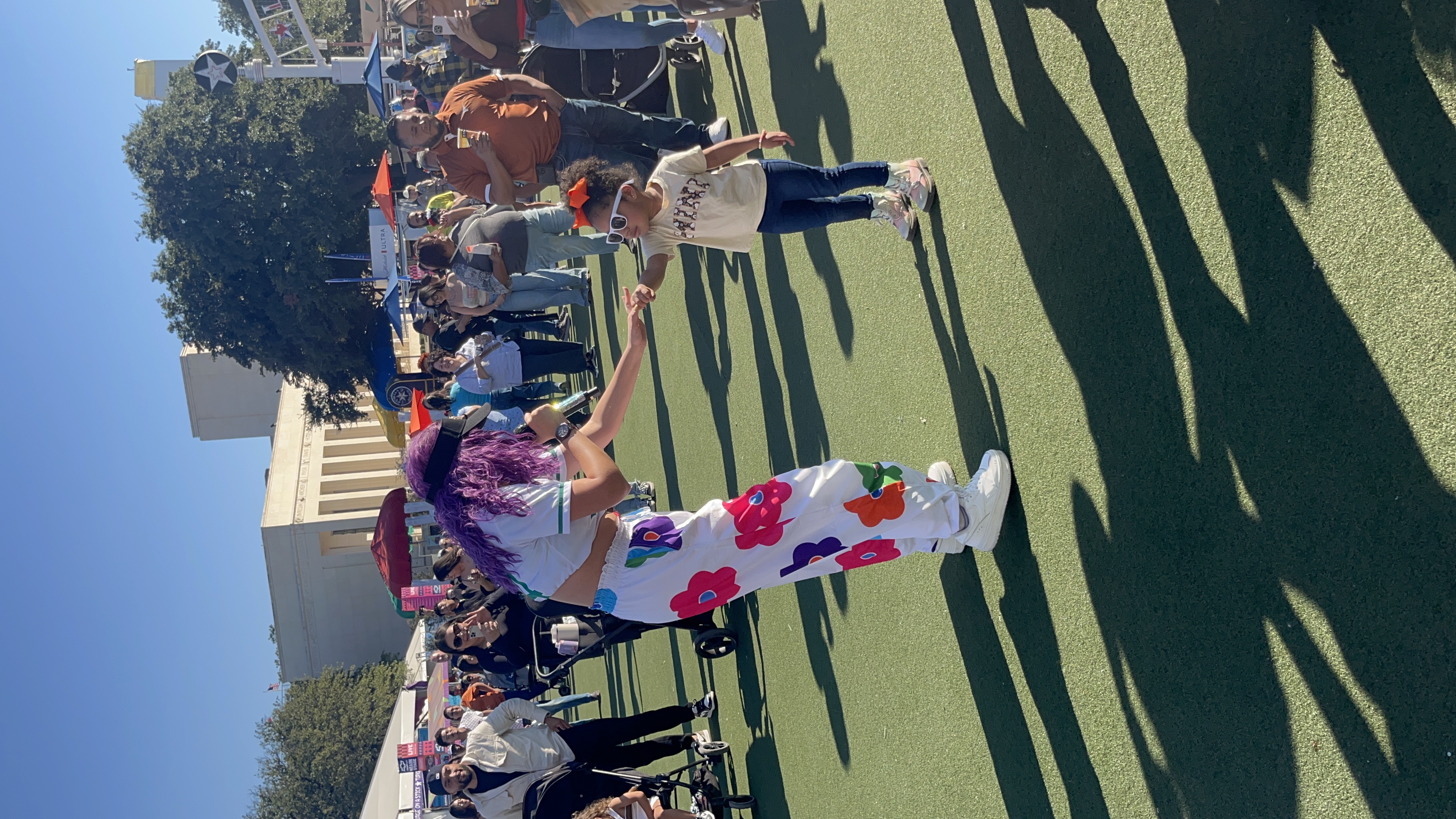 The lead vocalist of Sabor Puro dancing with a young girl in the crowd